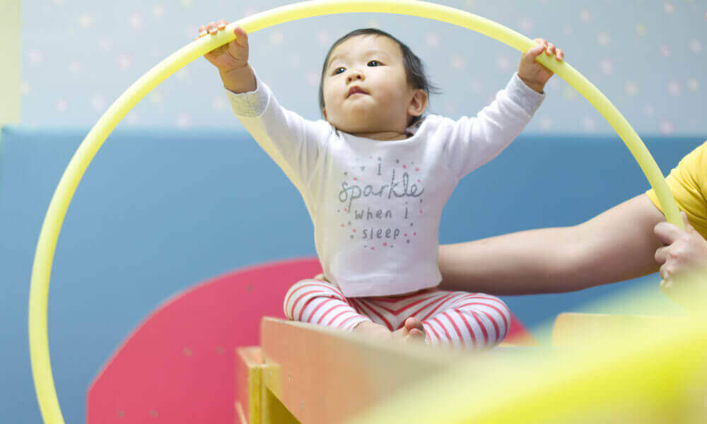 One year old playing with a circle.