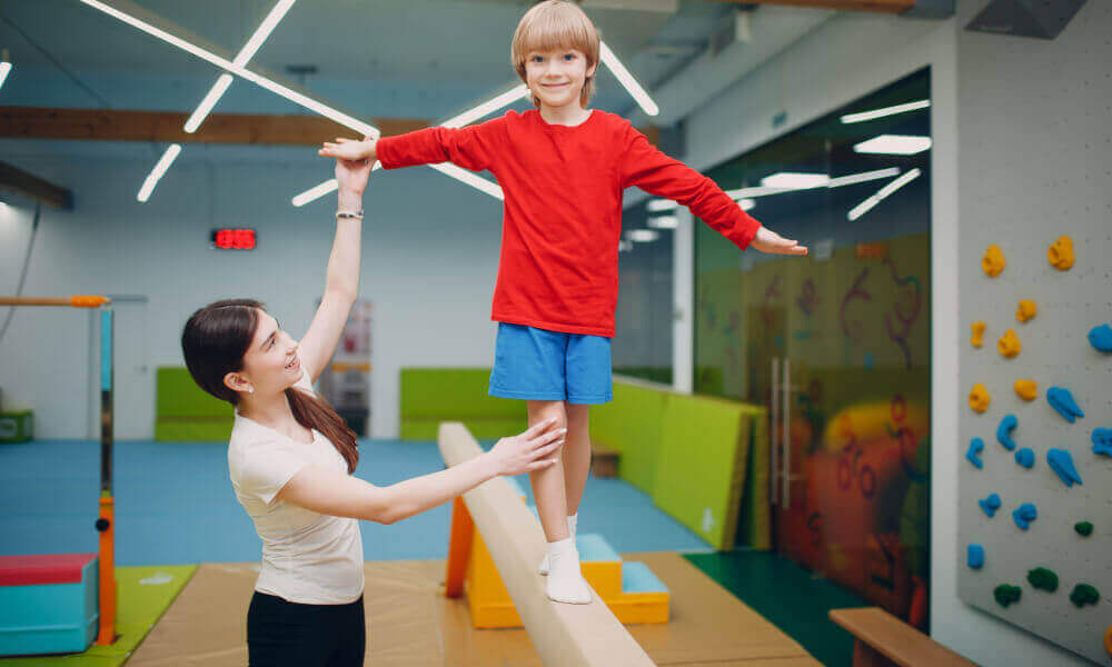 Six year old boy showing confidence on the balance beam