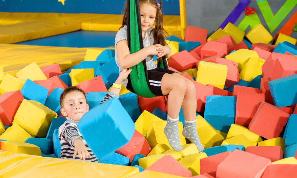 Six year olds in a gym play pit.